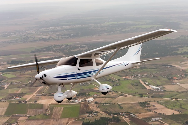 A small general aviation aircraft turns in uncontrolled airspace
