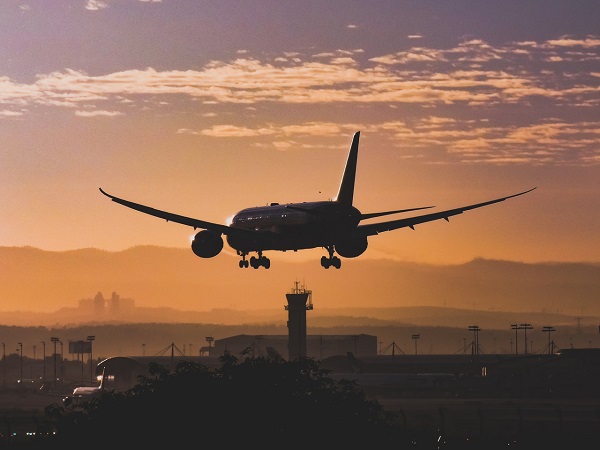 An aircraft lands just before sunset